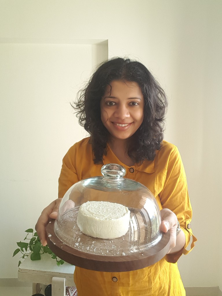Dhvani Desai holding a clotche of Cheese