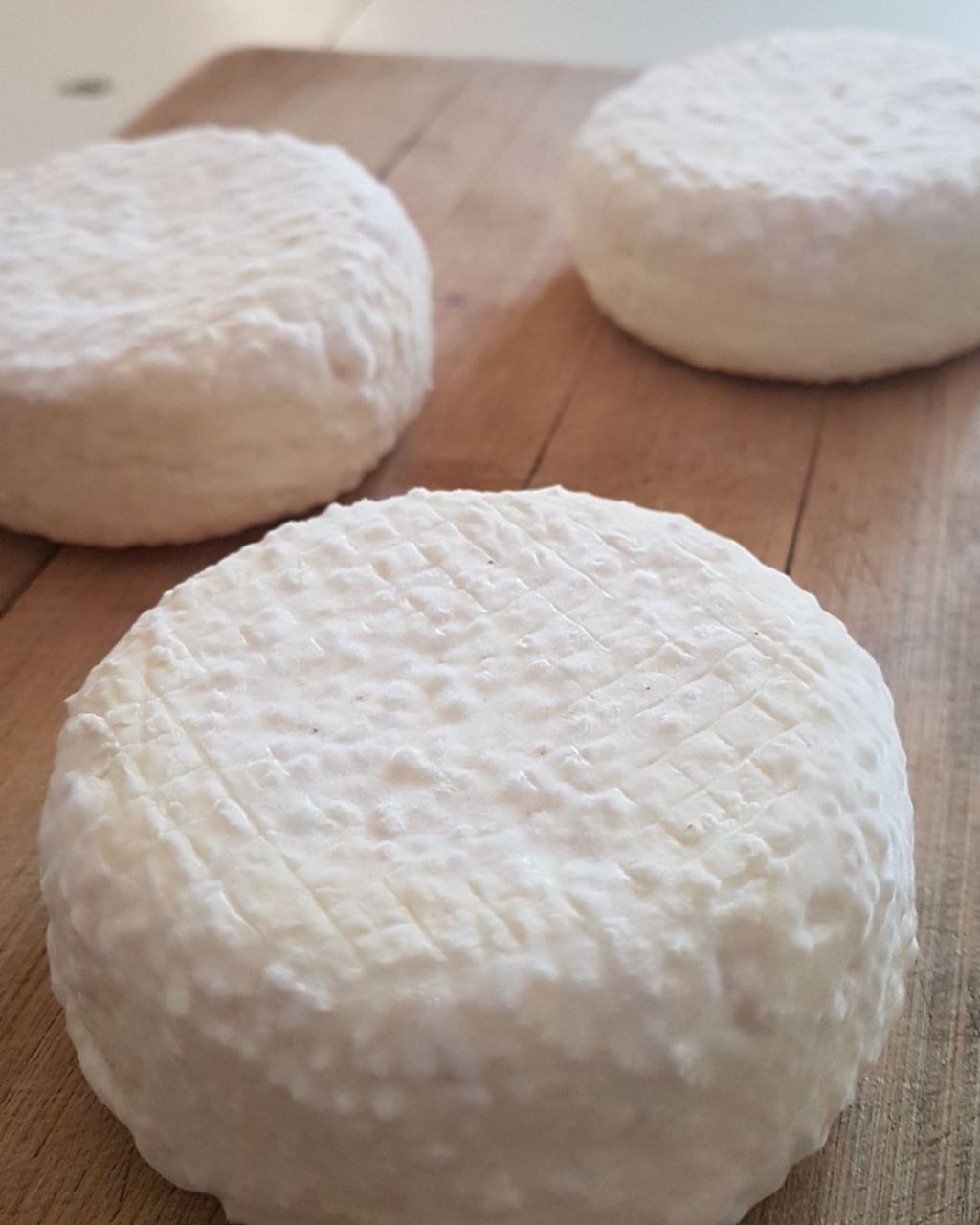 3 brie cheese medallions on a cheese board